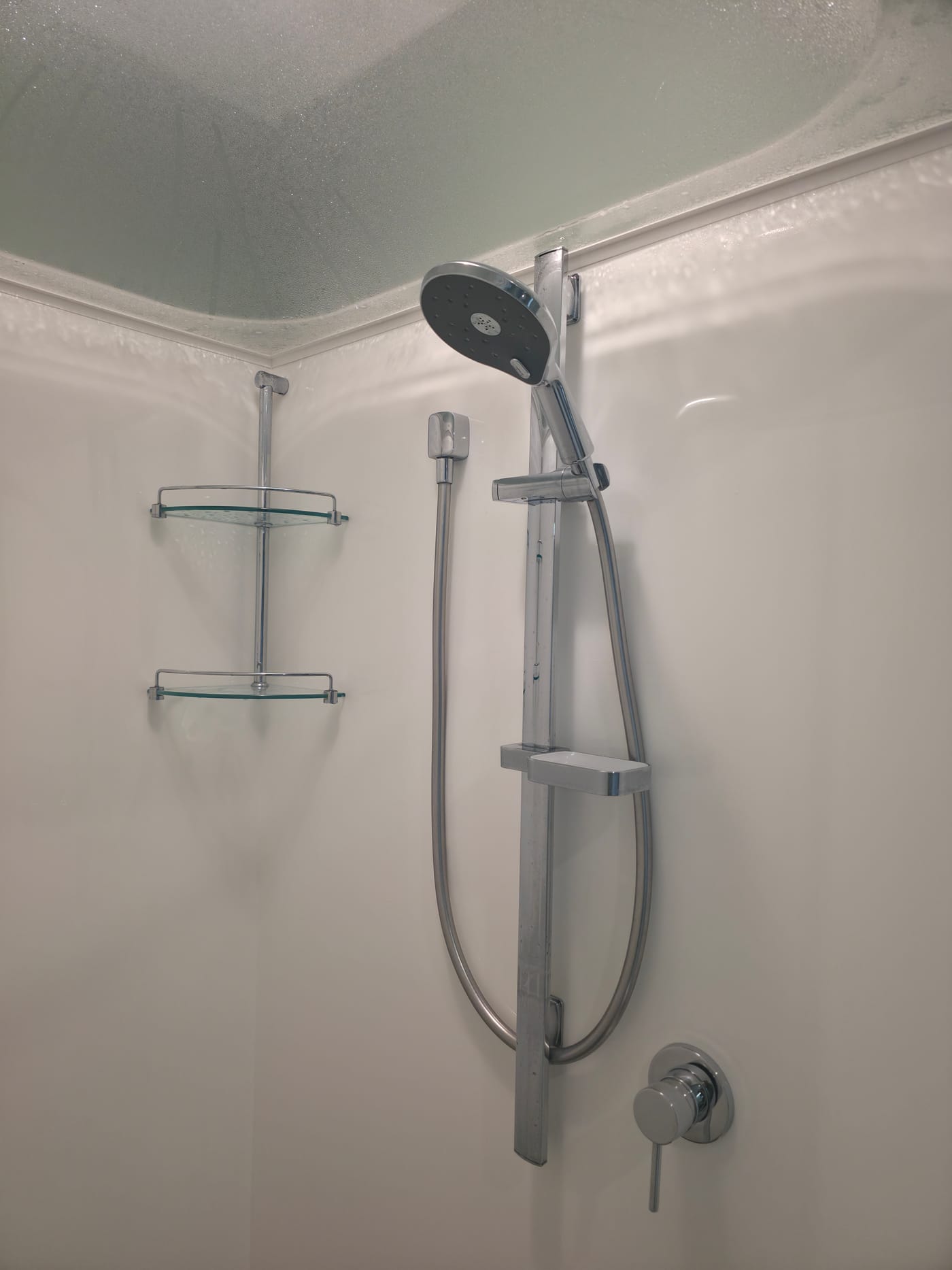 Chrome slide rail shower and mixer installed in a newly finished shower